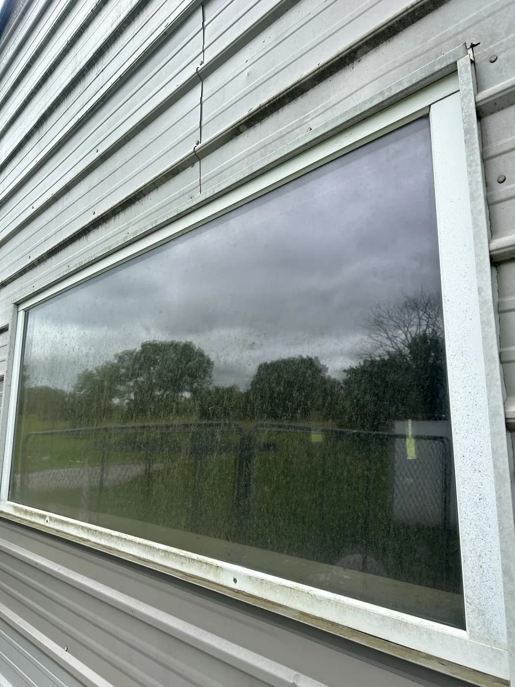 Window before washing by JB Window Washing in Olathe, glass hazy and spotted