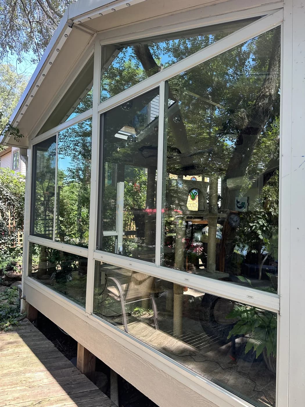 Sunroom glass after window washing in Olathe, sky and trees sitting in the panes